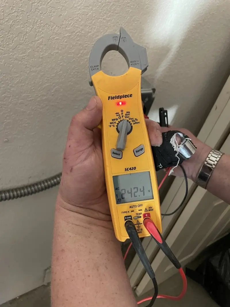 Voltage testing with clamp meter during Recessed Lighting Installation in Guilford